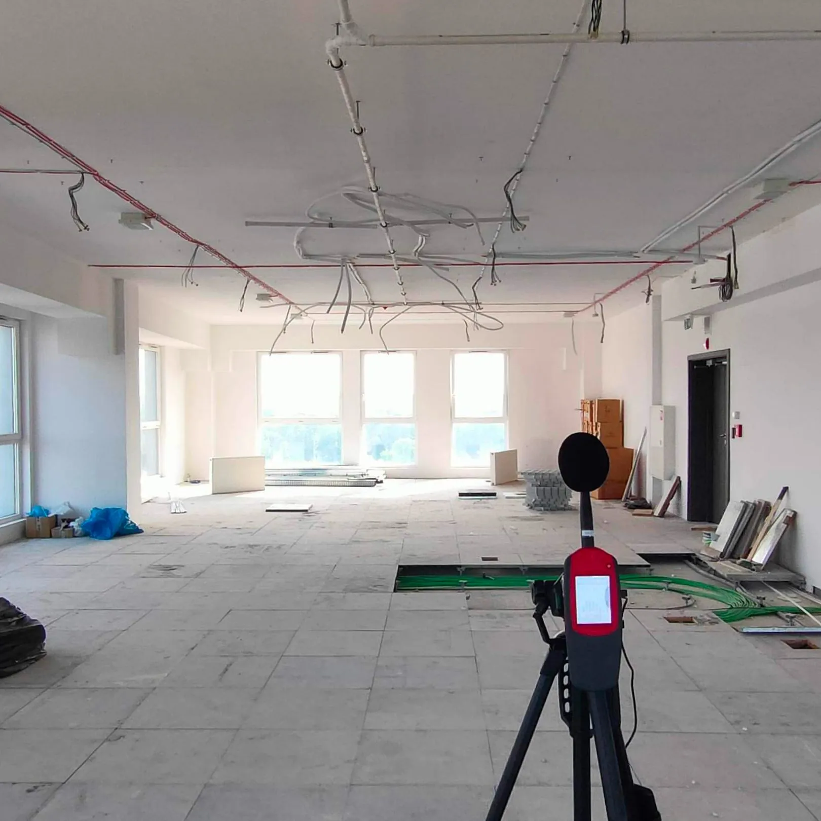 Acoustic measurements in the open-plan space being finished