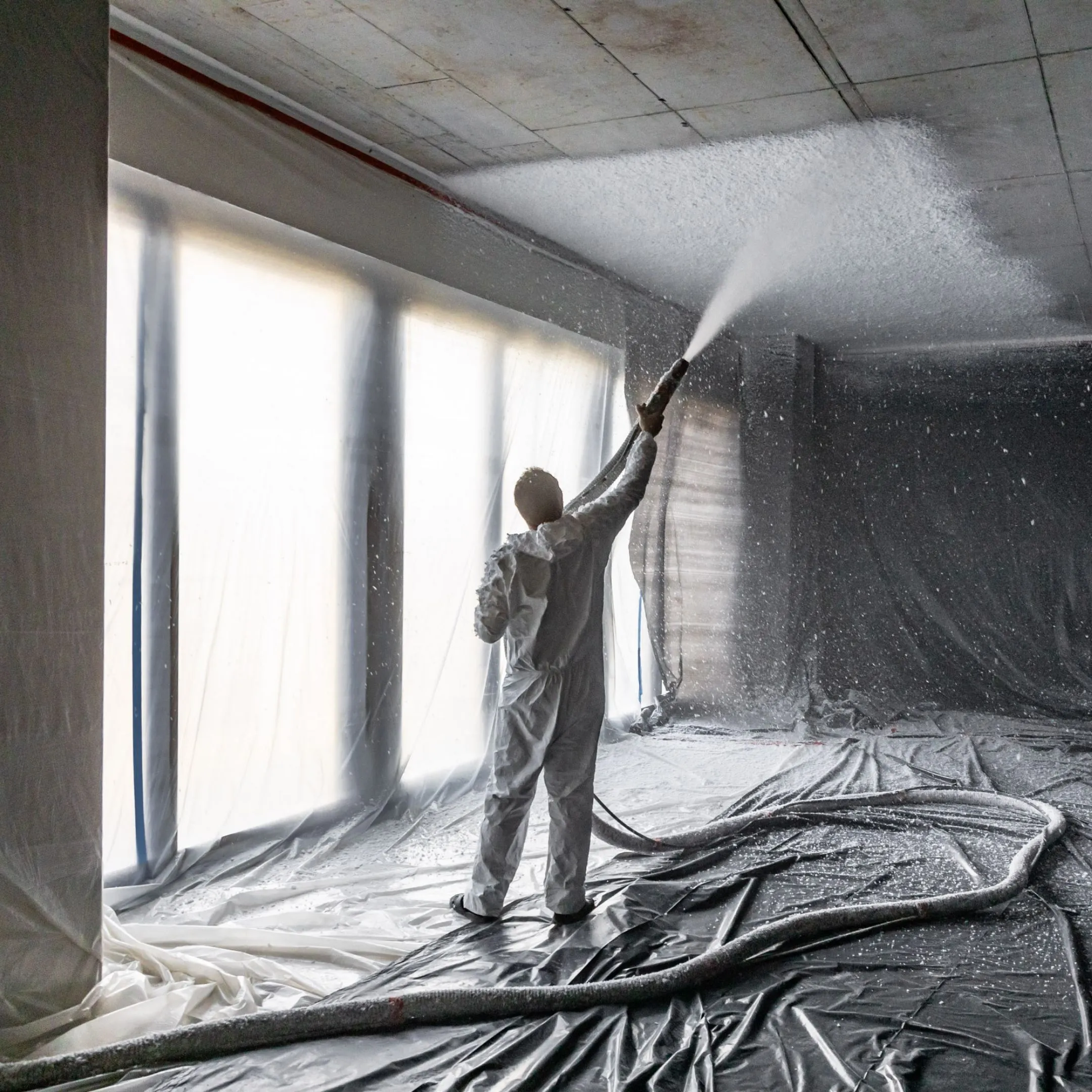 Spraying plaster on the ceiling